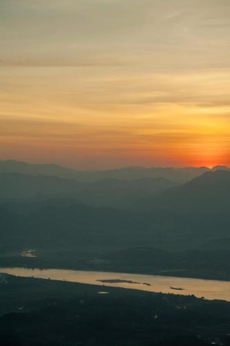 a view of a sunset over a body of water at Melia Ba Vi Mountain Retreat in Hanoi