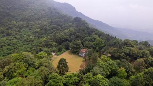 an aerial view of a house in the middle of a forest at Melia Ba Vi Mountain Retreat in Hanoi