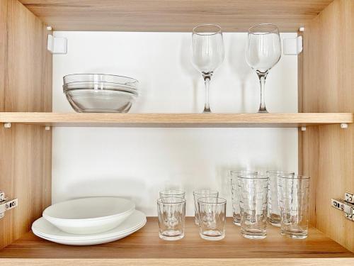 a wooden shelf with glasses and plates on it at Central Flat & Free Parking in Varna City