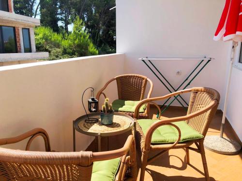 a patio with two chairs and a table on a porch at The Rooftop of Apartments Lungo Mare in Ulcinj
