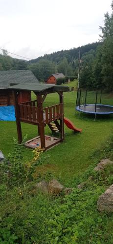 a picnic table and a trampoline in a park at Penzion Iva in Tanvald