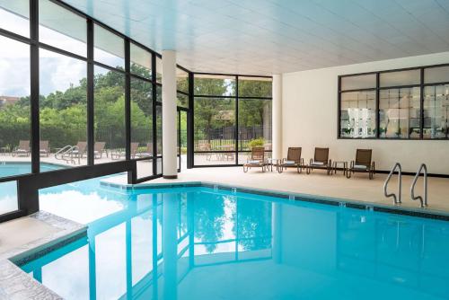 a swimming pool in a house with windows at Hilton Alexandria Mark Center in Alexandria