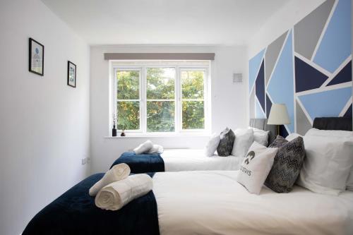 a bedroom with two beds and a window at 30 Percent Off Monthly Stays - Free Parking - Sky & Netflix in Borehamwood