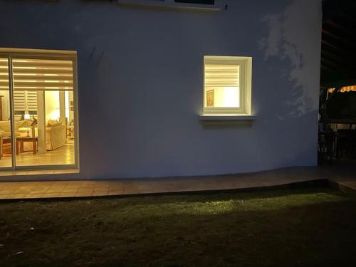 a house with two windows and a blue wall at Anglet Chiberta, les plages et le golf à pied. in Anglet