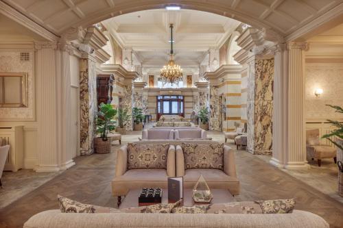 a living room with a couch and a chandelier at DoubleTree by Hilton Harrogate Majestic Hotel & Spa in Harrogate