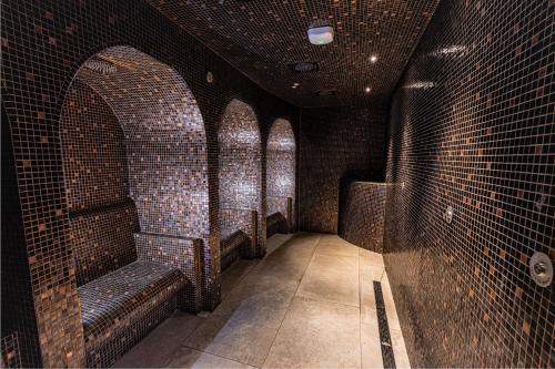 a room with brick walls and benches in a bar at DoubleTree by Hilton Harrogate Majestic Hotel & Spa in Harrogate