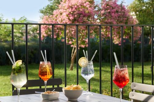 a table with four wine glasses on top of it at Hampton by Hilton Rome North Fiano Romano in Fiano Romano