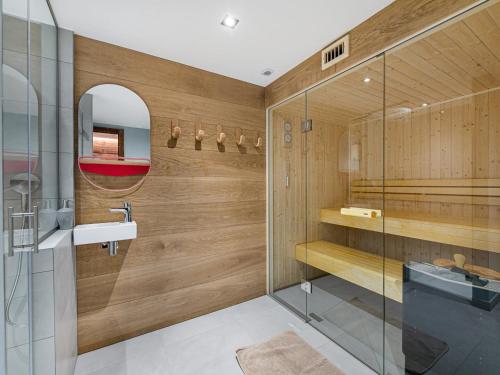 a bathroom with a shower and a sink and a mirror at Chalet familial 6 adultes et 5 enfants avec sauna à 300m des pistes et centre Méribel - FR-1-565-10 in Les Allues
