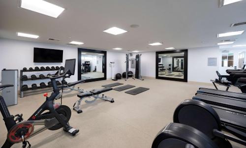 a gym with several treadmills and exercise bikes at Inn at the Pier Pismo Beach, Curio Collection by Hilton in Pismo Beach