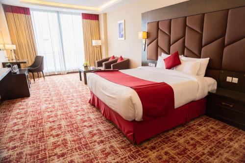 a hotel room with a large bed and a desk at Ramada by Wyndham Murree Lower Topa Resort in Murree