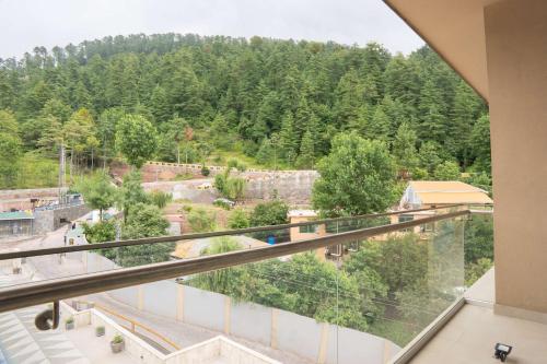 a view from the balcony of a building at Ramada by Wyndham Murree Lower Topa Resort in Murree