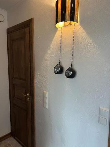 a hallway with two spoons hanging on a wall at Sepa Apartement in Kuressaare