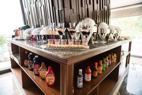 a buffet with wine glasses and bottles of alcohol at Ramada by Wyndham Murree Lower Topa Resort in Murree