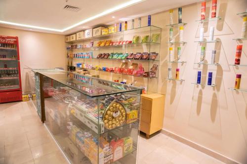 a grocery store aisle with shelves of food at Ramada by Wyndham Murree Lower Topa Resort in Murree