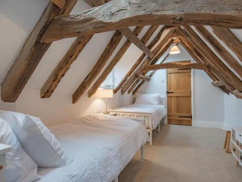 a bedroom with two beds in a attic at Townhouse with cathedral views in Kent