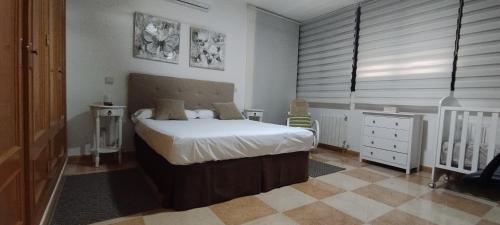 a bedroom with a bed and a crib in it at Idafe in Valdemaqueda