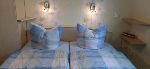 two pillows on top of a bed in a room at GRAHLS- Ferienapartement in Feldberg
