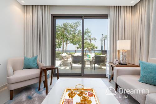 a living room with a view of the patio at Dream Inn - Address Beach Residence Fujairah - Premium Apartments in Fujairah