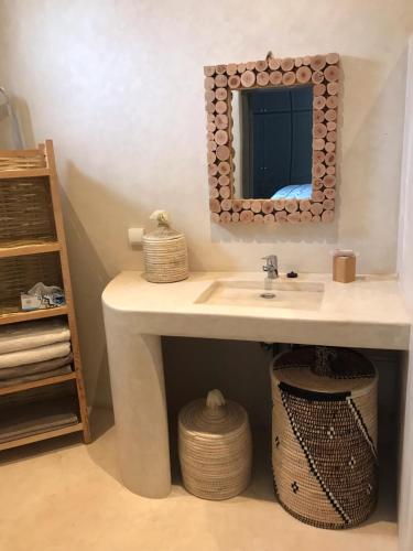 a bathroom with a sink and a mirror at VILLA PISCINE MARRAKECH in Marrakesh