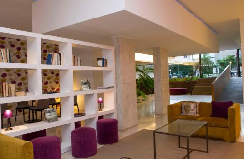 a living room with white shelves and purple accents at Dorisol Mimosa Studio Hotel in Funchal