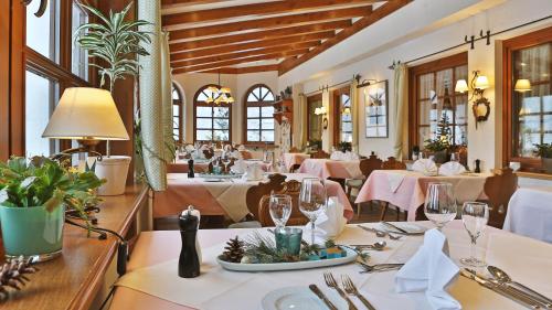 a dining room with tables with white tablecloths at Hotel Waldblick Kniebis in Kniebis