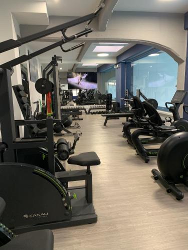 a gym with several rows of treadms and machines at My Bed Vatican Museum in Rome