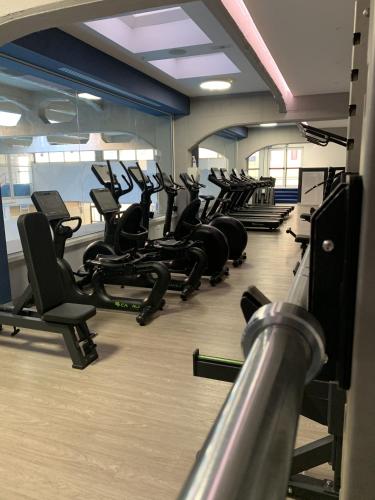 a gym with a row of treadmills and chairs at My Bed Vatican Museum in Rome