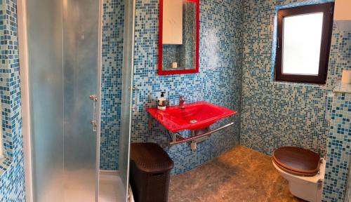 a bathroom with a red sink and a toilet at Bucharest Old Town Smardan Apartment in Bucharest