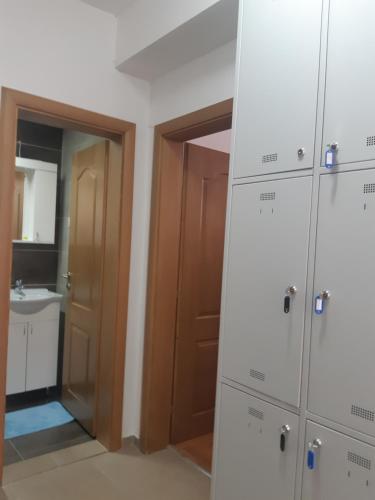 a bathroom with a closet and a sink at Railway Hostel in Skopje
