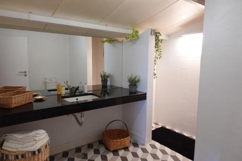 a bathroom with a sink and a mirror at Casa Pereirinha \ Pateo House in Vidigueira