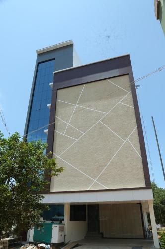 a building with a painting on the side of it at HOTEL TAWFEEQ PALACE in Thanjāvūr