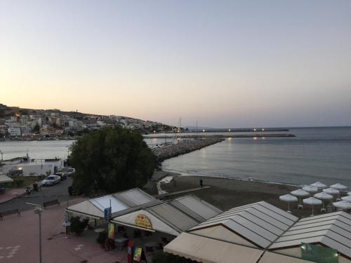 a view of a beach with a pier and the water at Apollon Hotel in Sitia