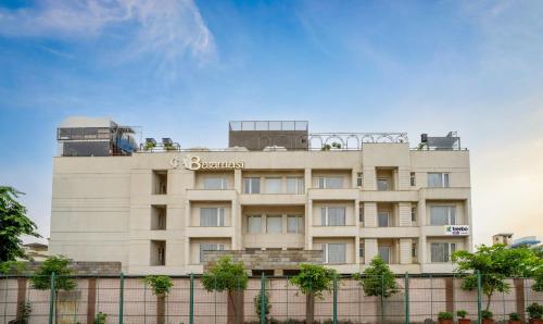 a tan building with a sign on top of it at Treebo Tryst Baramasi By Jai Club Prime in Jaipur