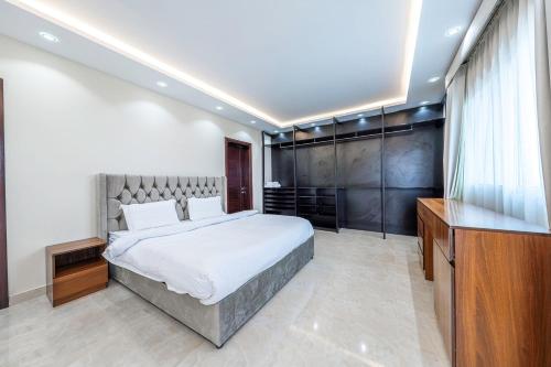a bedroom with a large bed and a television at Mabaat - Almasarat Tower Al Shati - 531 in Jeddah