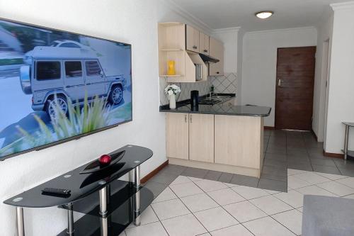 a kitchen with a large picture of a truck on the wall at Spacious Hatfield Apartment in Pretoria