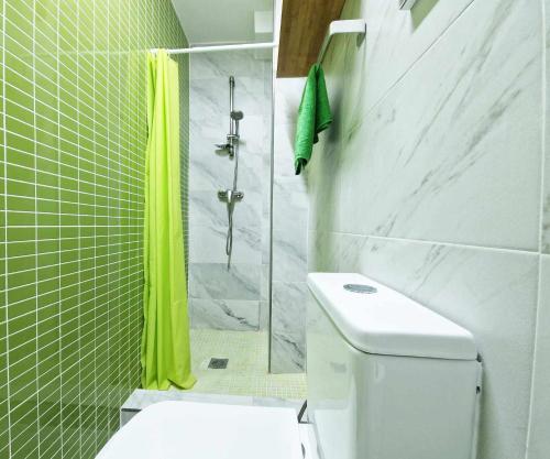 a bathroom with a toilet and a shower with yellow curtains at Studio Simon 2 Murcia in Murcia