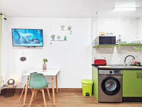 a kitchen with a table and a washing machine at Studio Simon 2 Murcia in Murcia