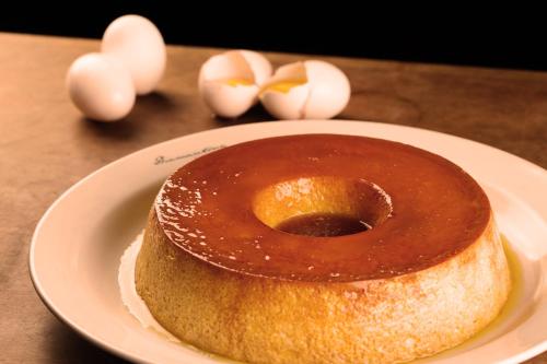 a chocolate covered doughnut on a plate with eggs at Kubitschek Plaza Hotel in Brasilia