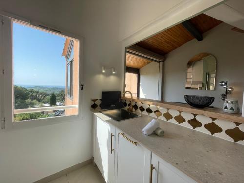a bathroom with a sink and a large window at "L'Horizon Bleu" Vue mer - 2 chambres - Parking - Piscine in La Croix-Valmer