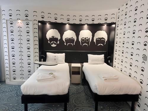 two beds in a room with skulls on the wall at Ibis Styles Liverpool Centre Dale Street - Cavern Quarter in Liverpool