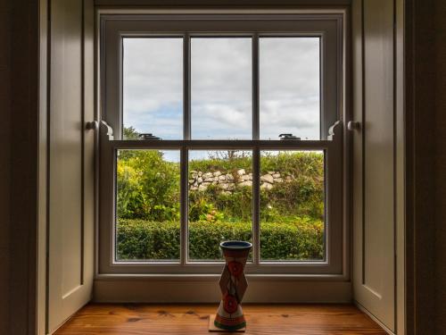 a vase sitting in front of a window at Rosecott in St Ives