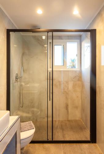 a glass shower in a bathroom with a toilet at Bella Foresta Villa II in Rhodes Town