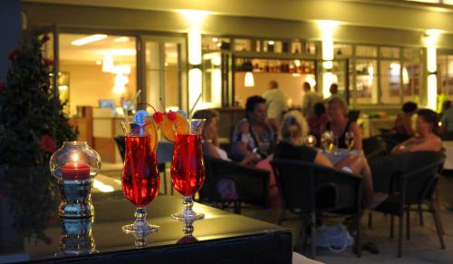 a table with two wine glasses on top of it at Dei Hotel Schönblick in Velden am Wörthersee