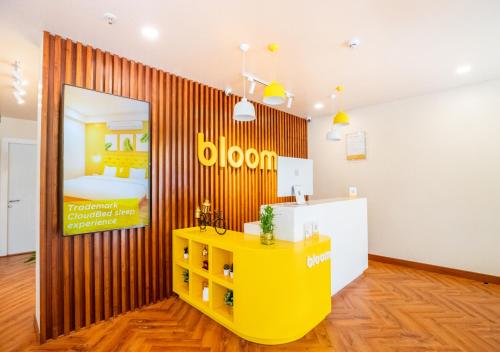 a room with a yellow table and a bed at Bloom Hotel - HSR Layout Sec 6 in Bengaluru