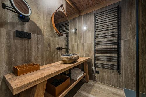 a bathroom with a wooden counter and a sink at Nový pokoj Hotelu Emerich in Pec pod Sněžkou