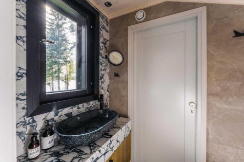 baño con lavabo y ventana en PihlasResort, en Joroinen