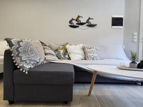 ein Sofa mit Kissen und einen Tisch im Wohnzimmer in der Unterkunft Little Fox Corfu 3 in Alepou