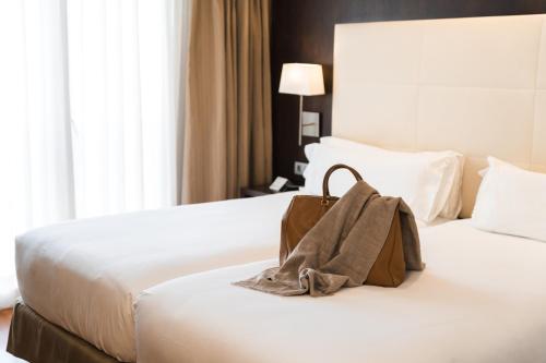 a brown bag sitting on a bed in a hotel room at Hotel Taburiente S.C.Tenerife in Santa Cruz de Tenerife