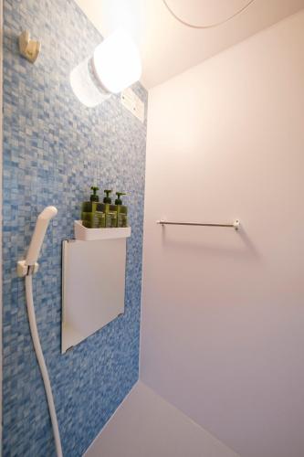 a bathroom with wine bottles on a shelf at Panari in Miyako-jima