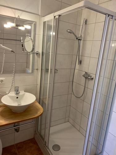 a bathroom with a shower and a sink at Ferienwohnung "Zirbenduft" im Landhotel Seeg in Seeg